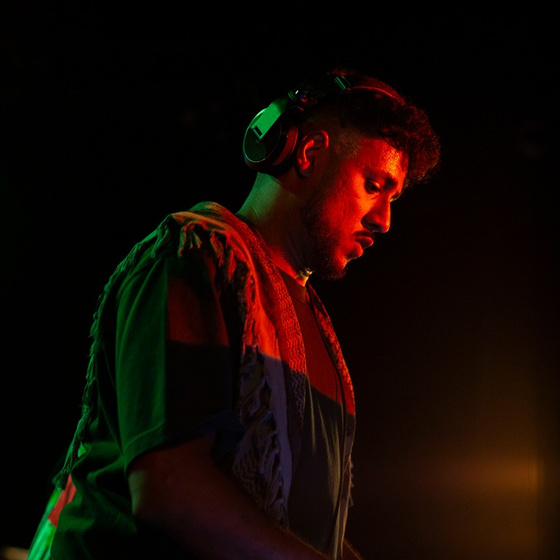 Kay Jay performing under red light