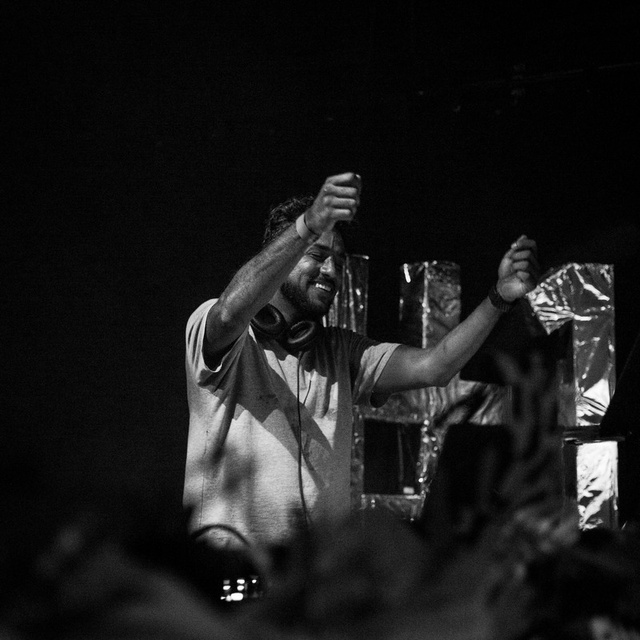 Kay Jay behind the decks in black and white